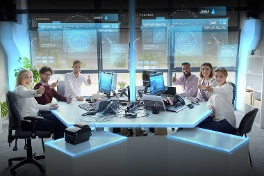 Business team with computers projecting hologram displays and showing thumbs up