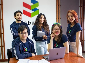 Ecuador employees smiling inside a modern office (Quito)