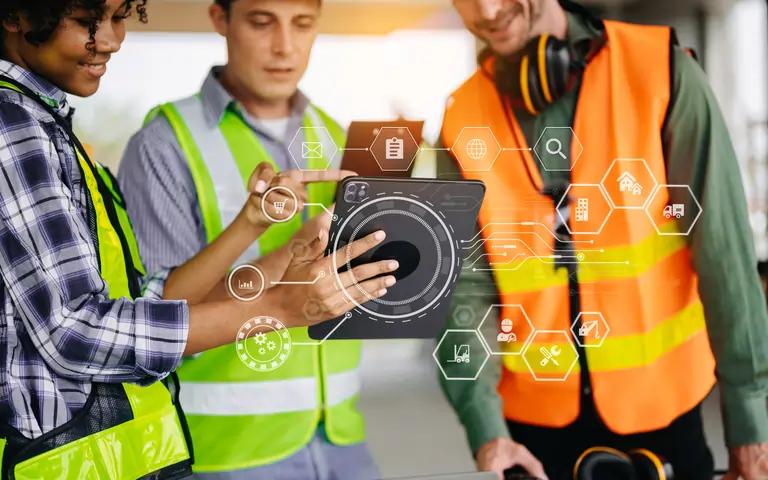 Colleagues discussing in front of a tablet
