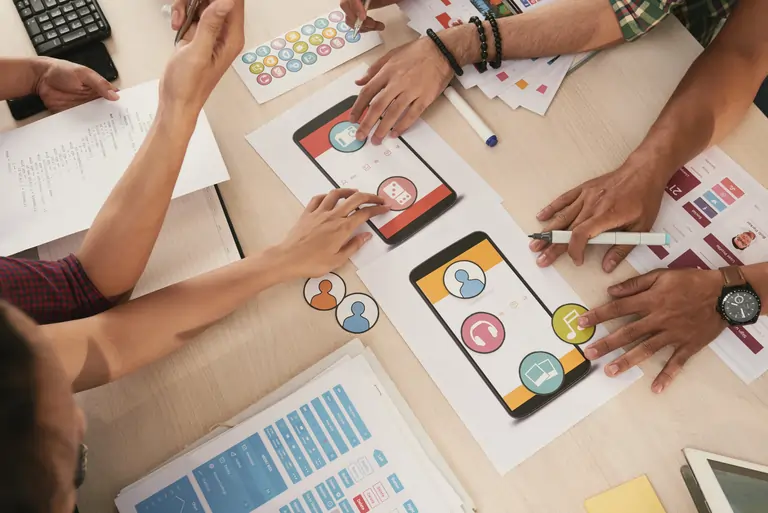Group of people choosing icons for a new app