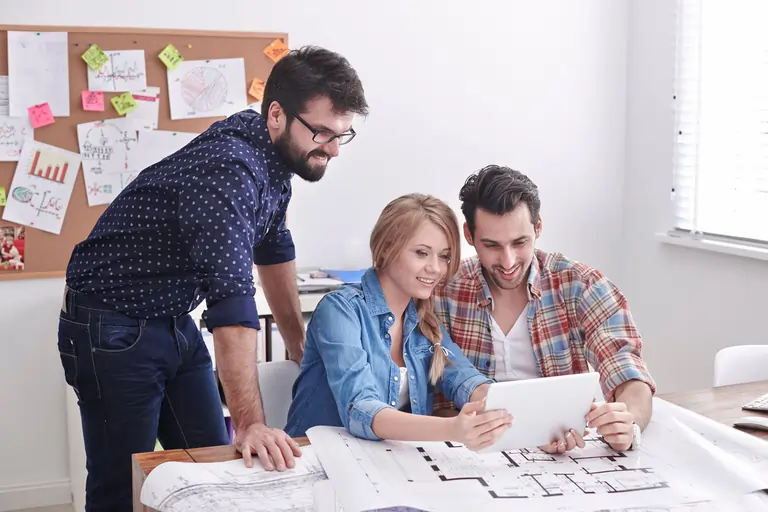 A group of young business partners working in a modern office